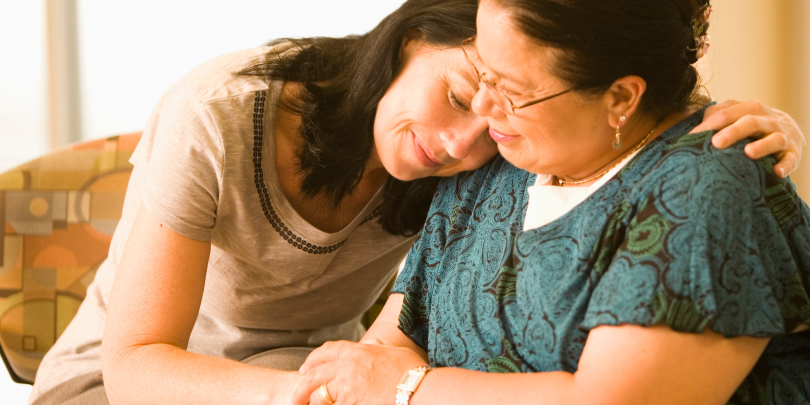 A woman hugs her mother