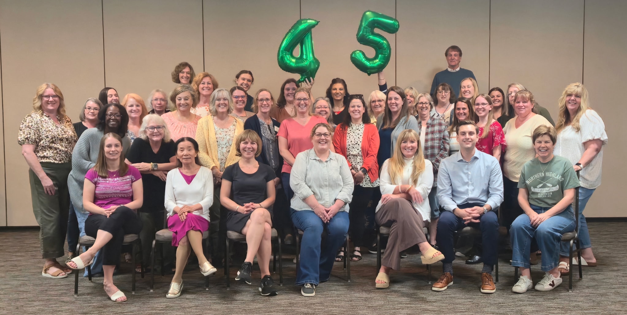 Group photo of BOALTC staff holding 45th anniversary balloons