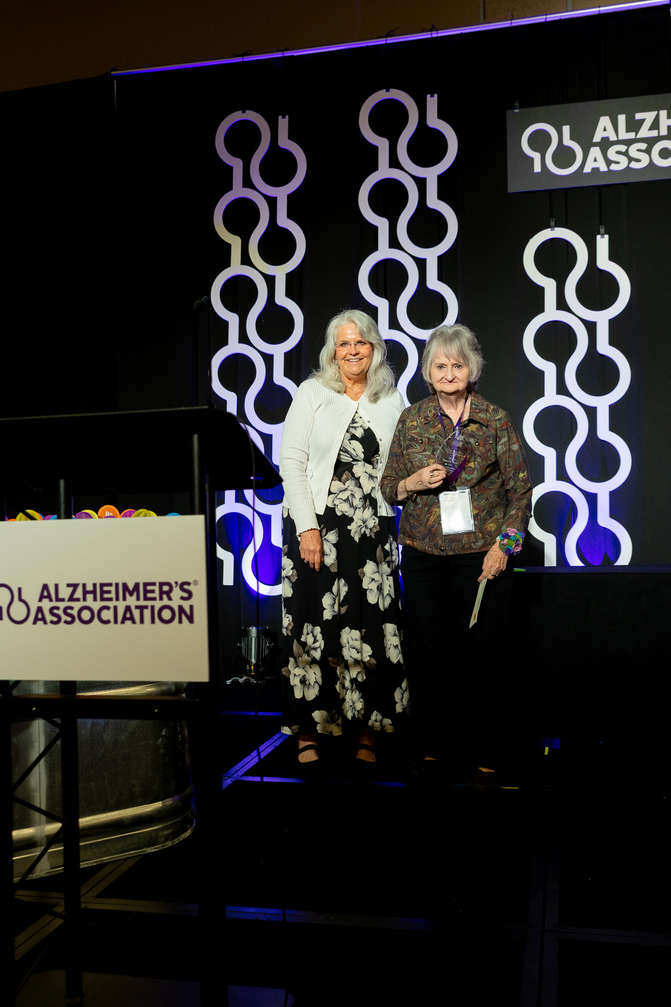 Carrie Russert and Dr. Valerie Palarksi pose on stage at the award ceremony